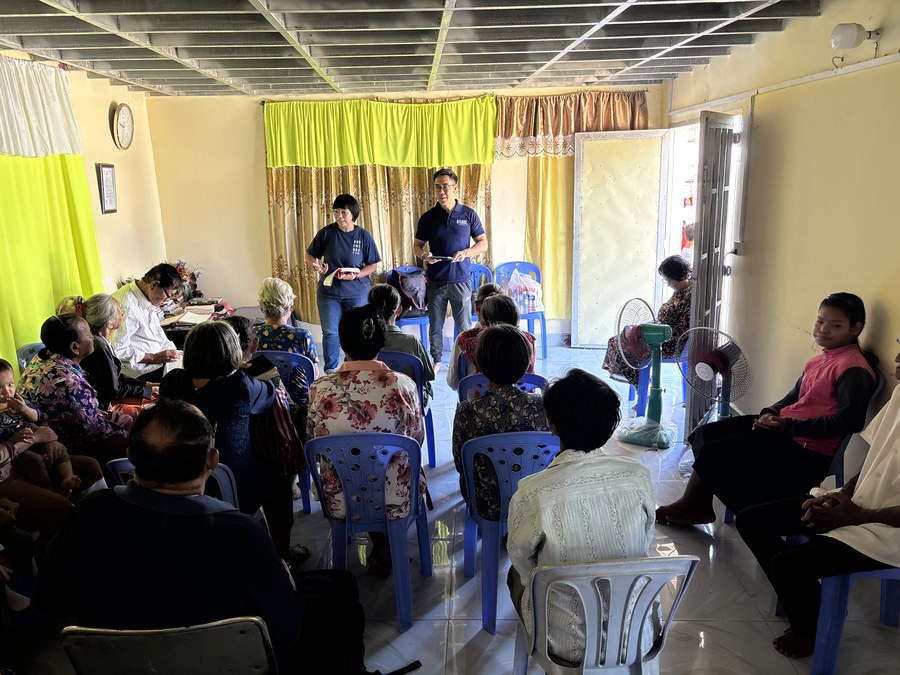 Community members worshipping together at fellowship in Chouk Va Mouy