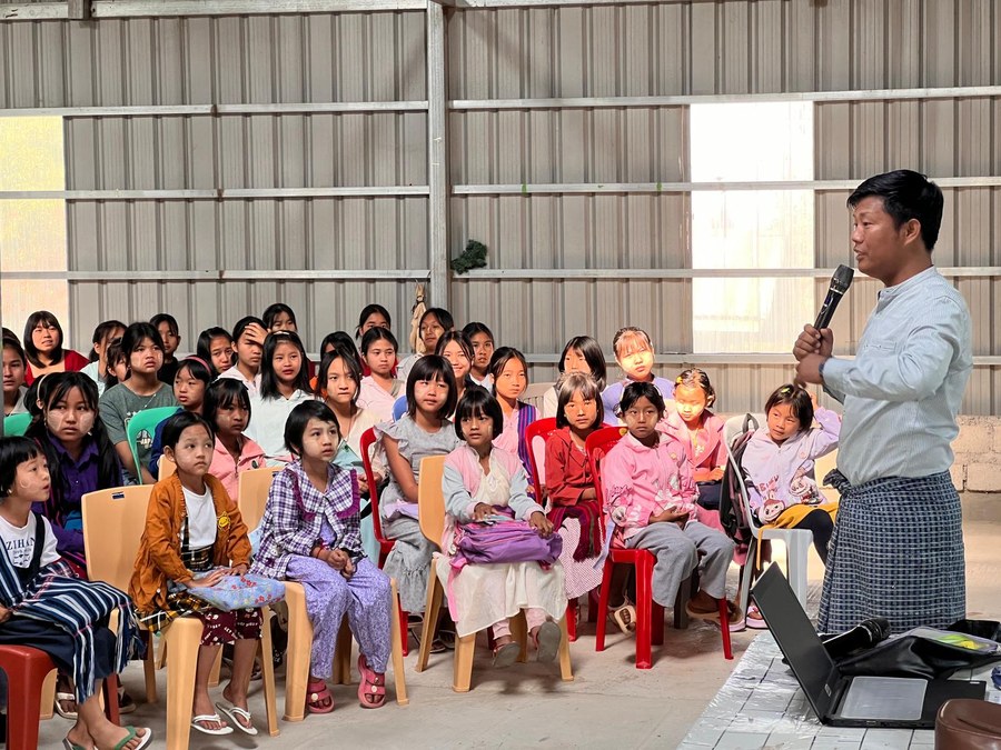 A speaker teaching young people at Summer Camp in Myanmar